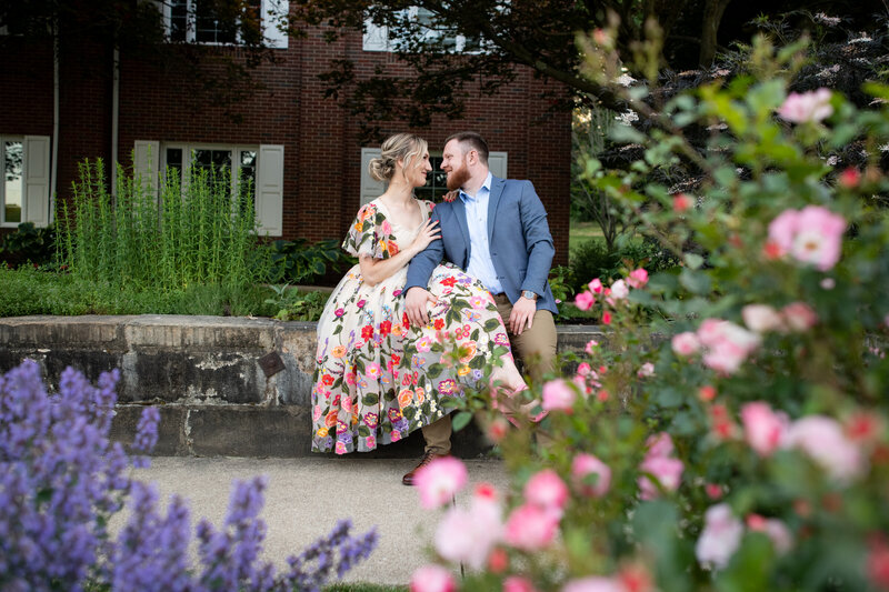 Happy Couple sit on stone wall at Canton Garden Center