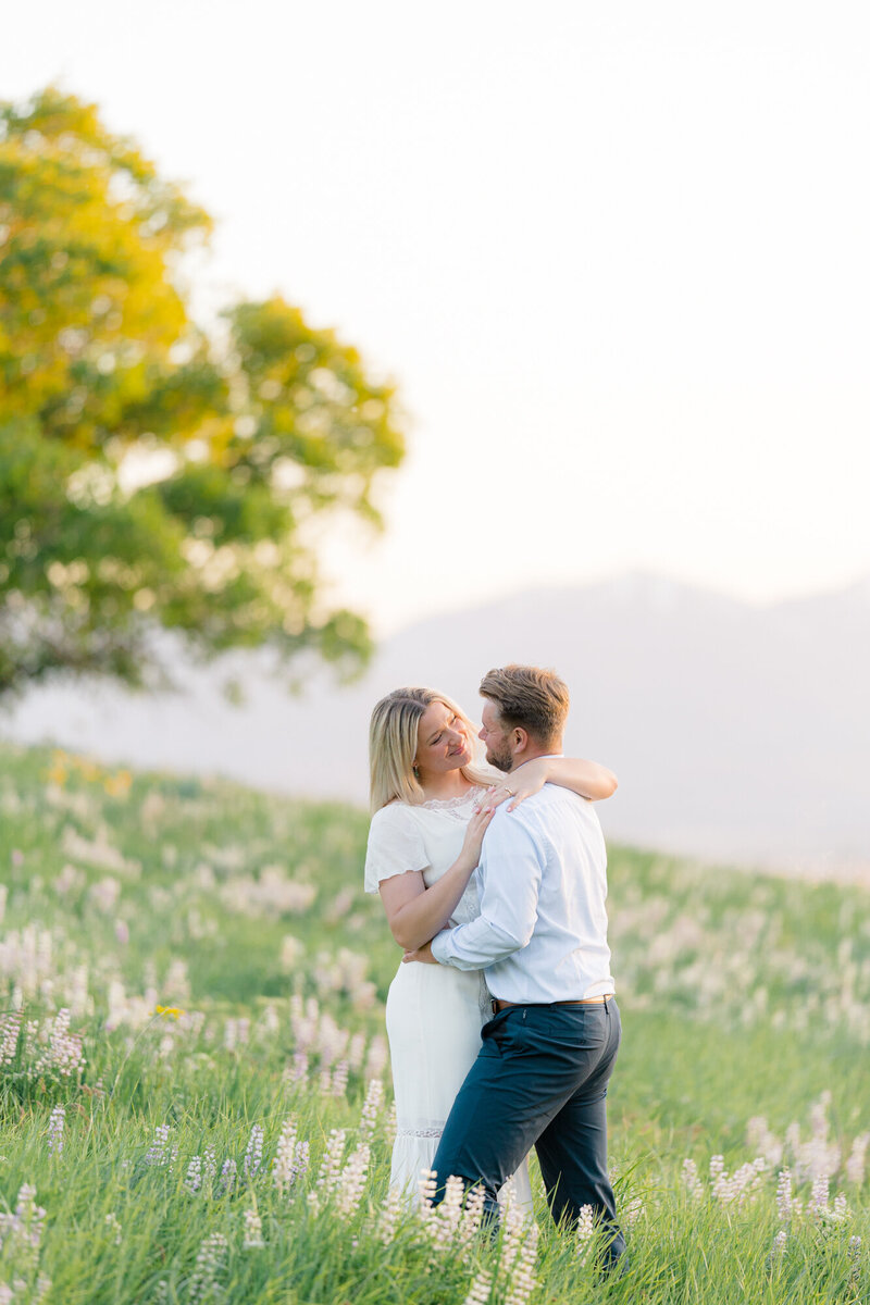 couple standing in wild flowers