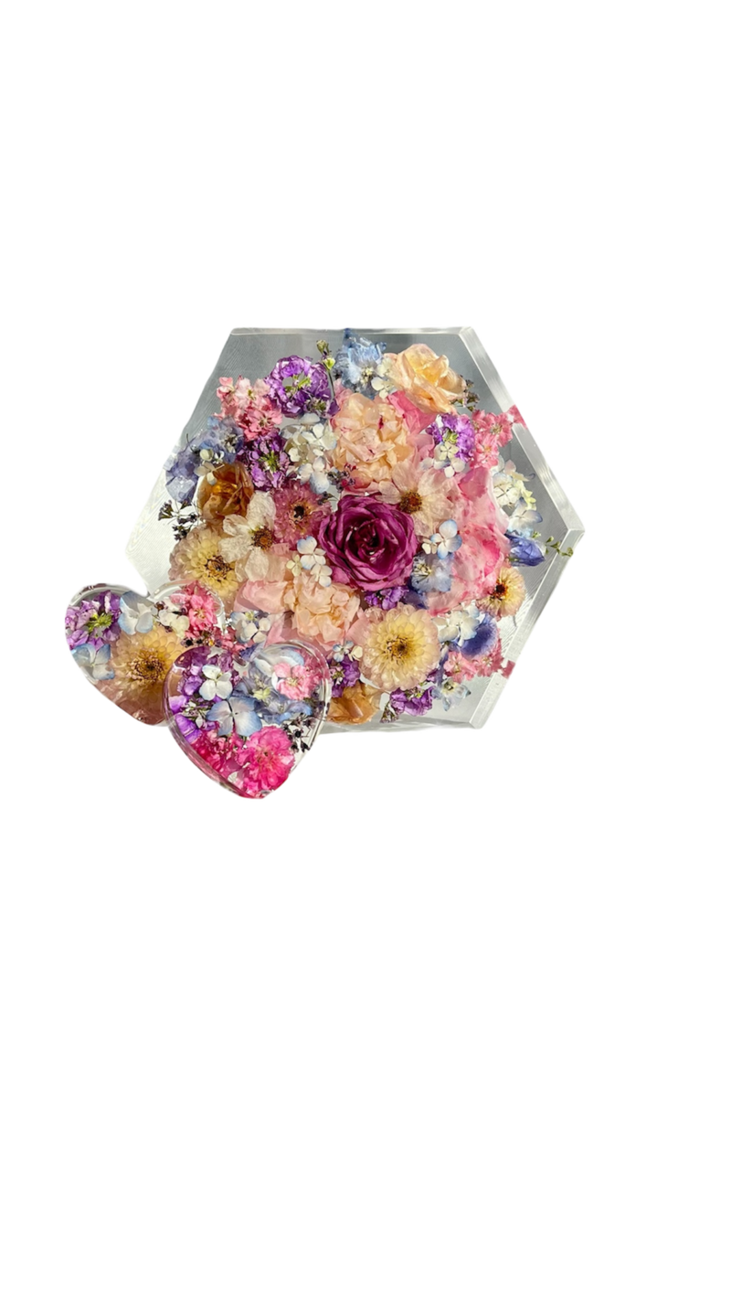 pink and burgundy funeral casket flowers laying on top of a casket