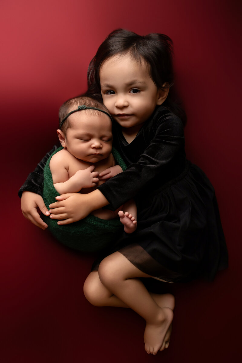 newborn photographer in woodland, ca. sisters. sibling photos. newborn session. photography studio. portraits. baby girl. newborn photography