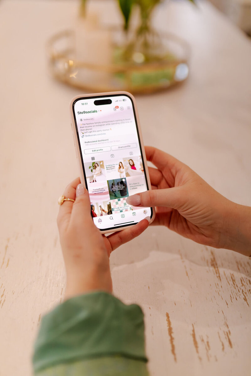 Social Media Manager scrolling on phone