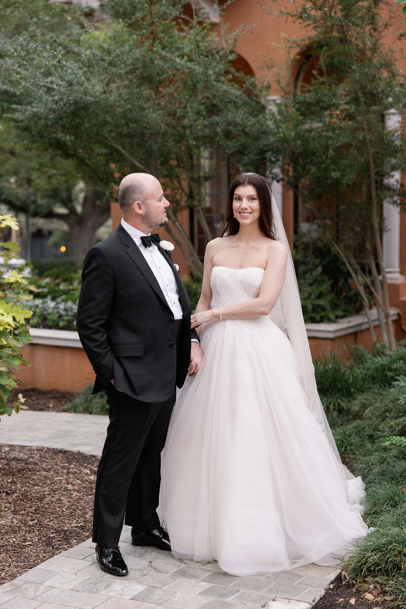 Bride and groom portraits at Rosewood Mansion on Turtle Creek, with the bride in a tulle ballgown and the groom in a tuxedo