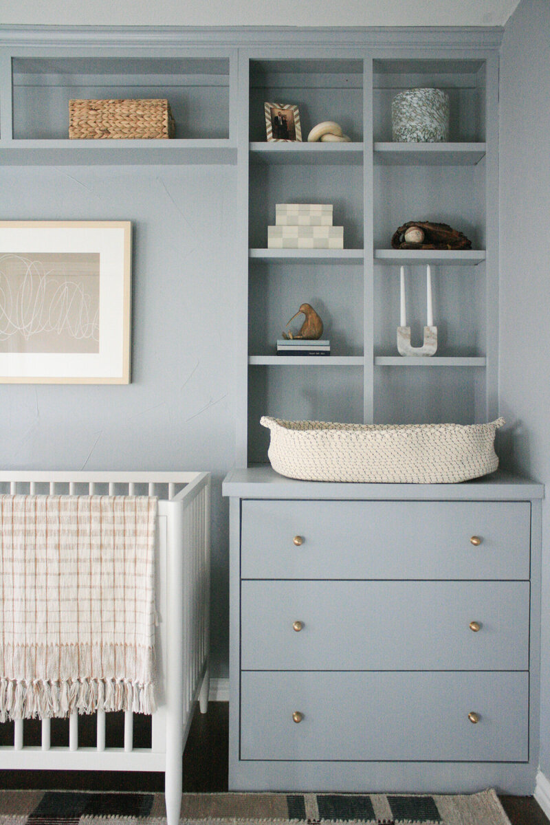 Baby nursery with blue built-ins designed by Hope Miriam Designs in DFW