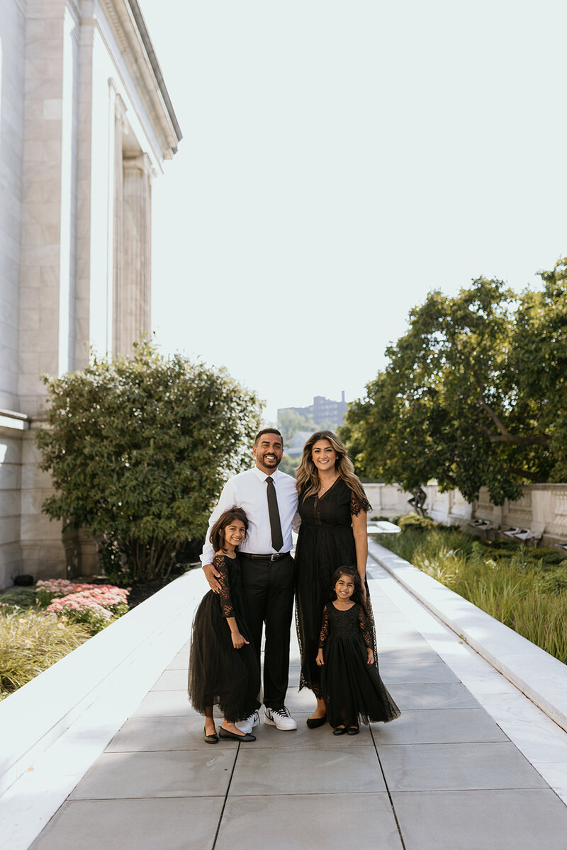 A family of four poses outside of a museum in DC.
