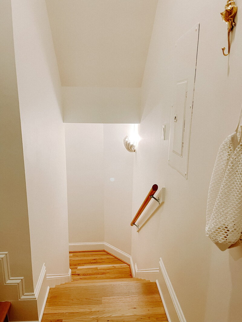 white stairwell with wood floors