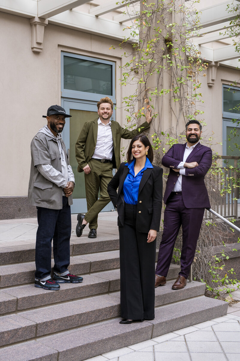 Aileen poses for a portrait shoot in the desert, bright lipstick and accented by foliage