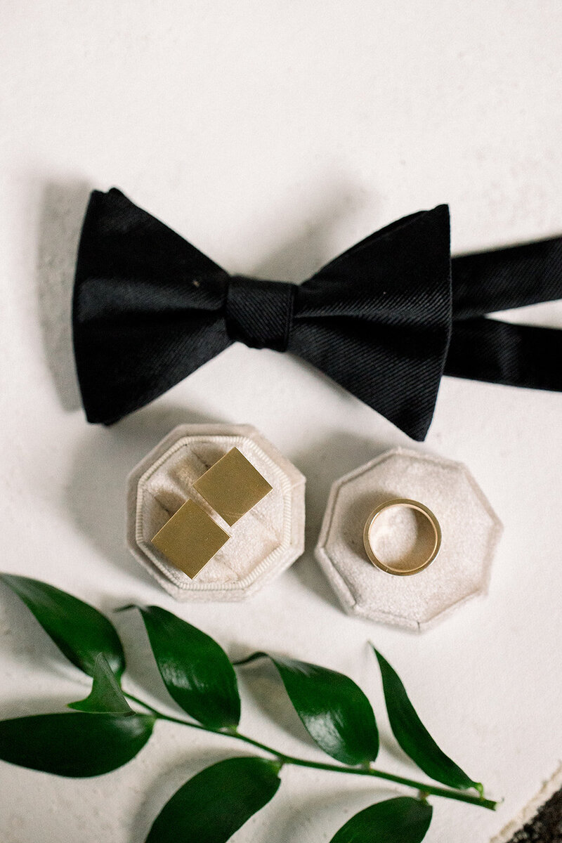flat lay of bowtie and cufflinks