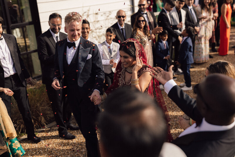 Wedding photographer captures couple taking a stroll hand in hand at their french chateau wedding.