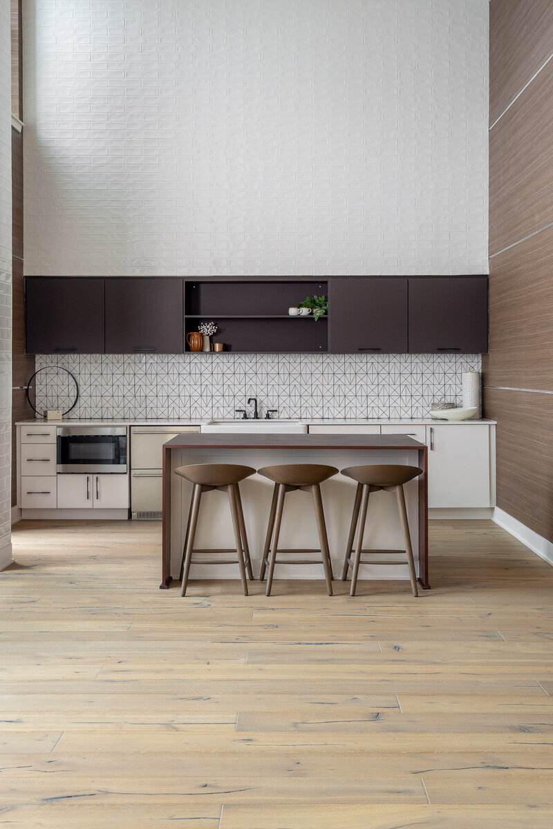 Commercial apartment lobby and clubhouse design. Featuring a variety of seating spaces, full-sized modern kitchen, and entryway. Design by Gracious Home Interiors, luxury interior designer in Waxhaw, North Carolina and across the east coast.