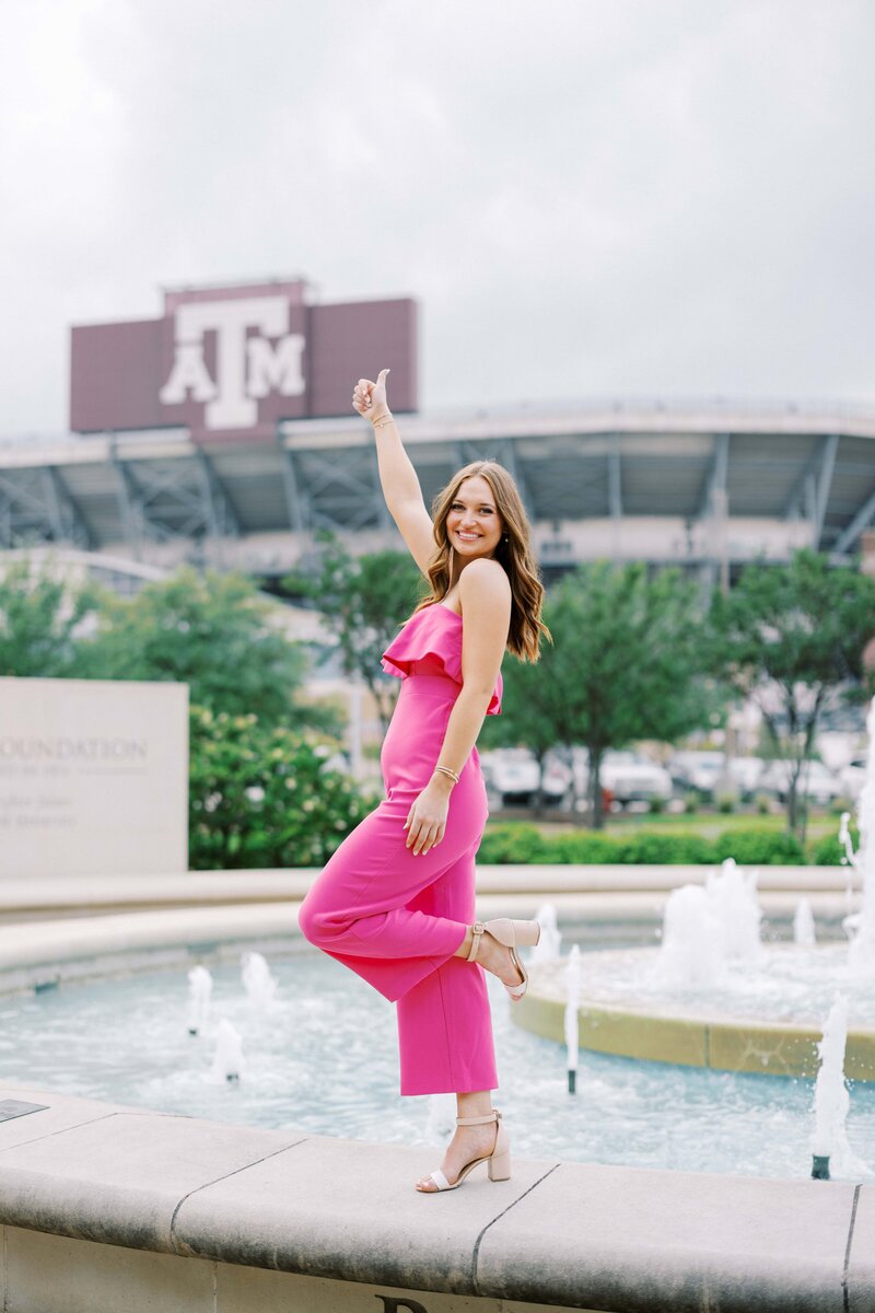 Senior in front of  Kyle Field at texas A&M with a gig' em! 