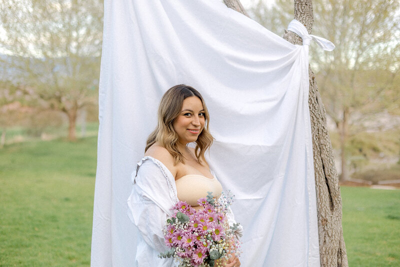 Bre smiles while holding flowers