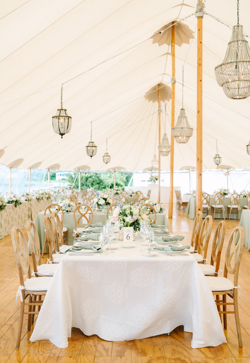 vertical image of a reception table during a luxury tented wedding in hingham massachusetts