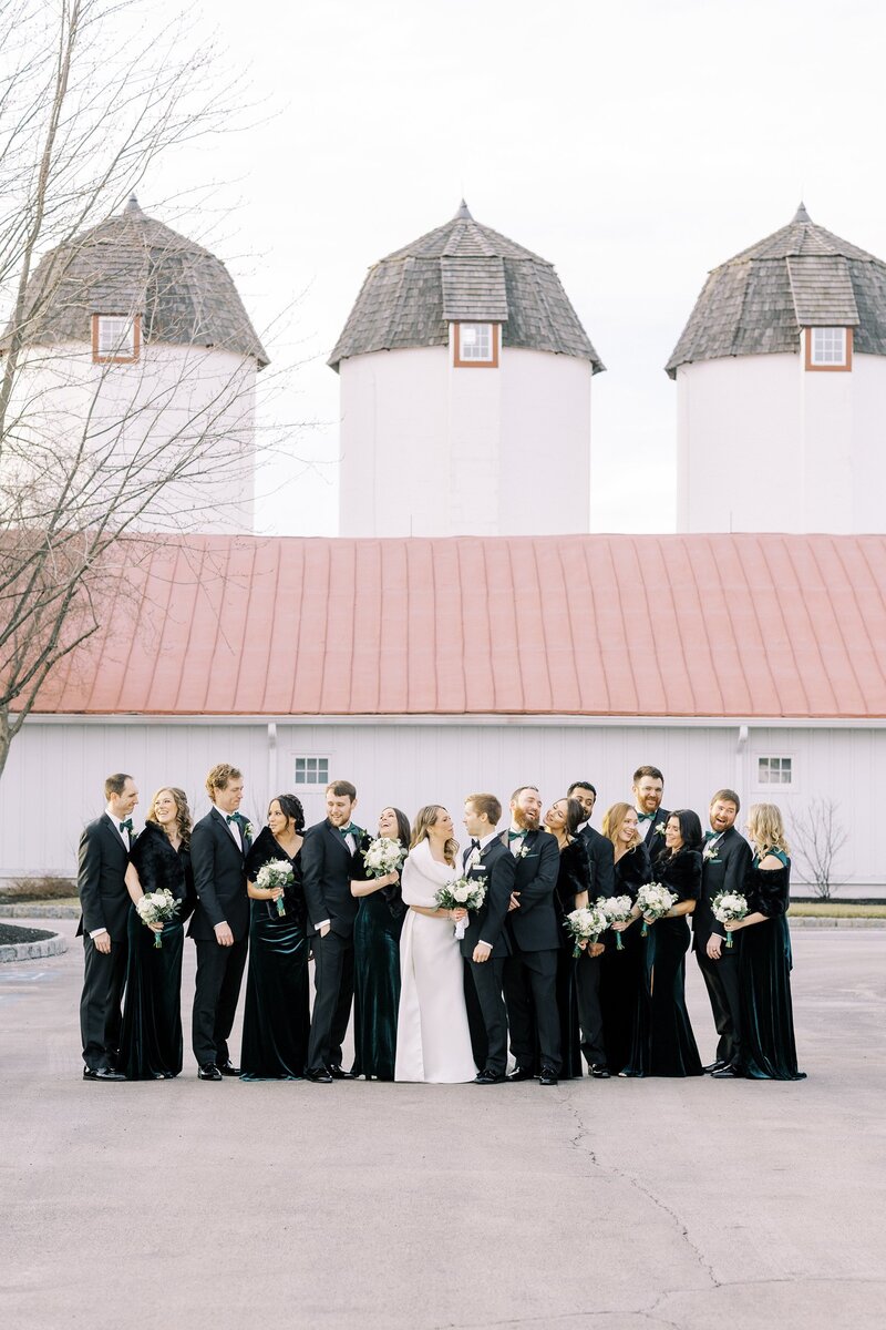 Bridal party in front of barn-style wedding venue