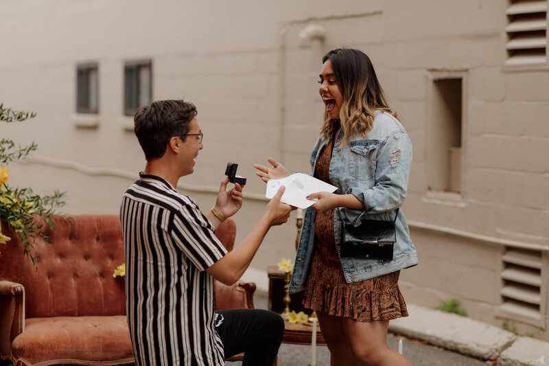 girl accepting ring after proposal and looking shocked