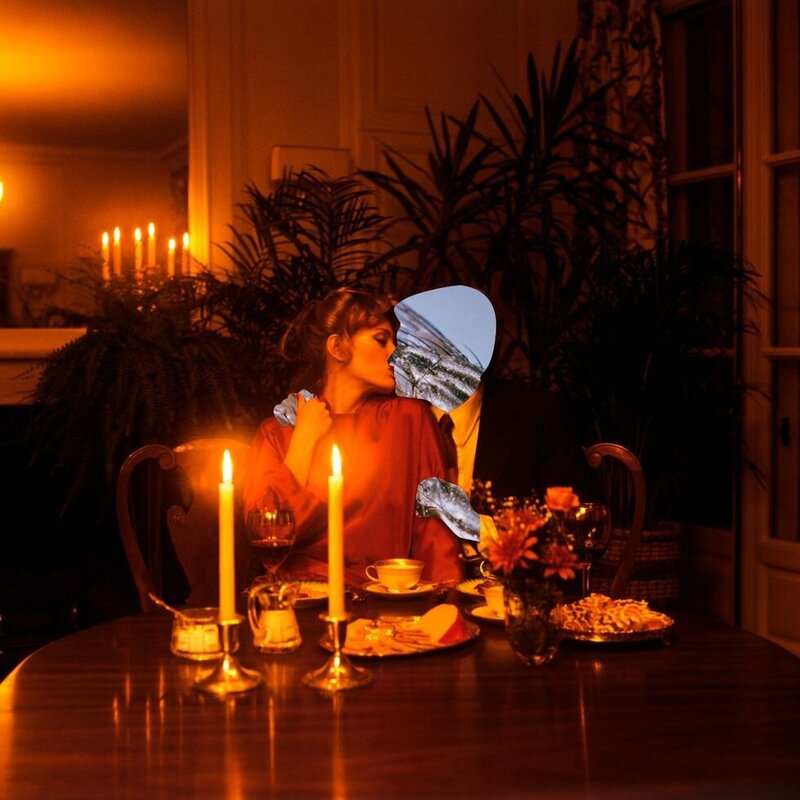 This image was sourced from the accompanying Cosmopolitan article, to which it links. The photo shows two people sitting at a candle-lit kitchen table, embracing and kissing. One person’s face and hands have been replaced with glittery blue shapes, making them appear invisible.
