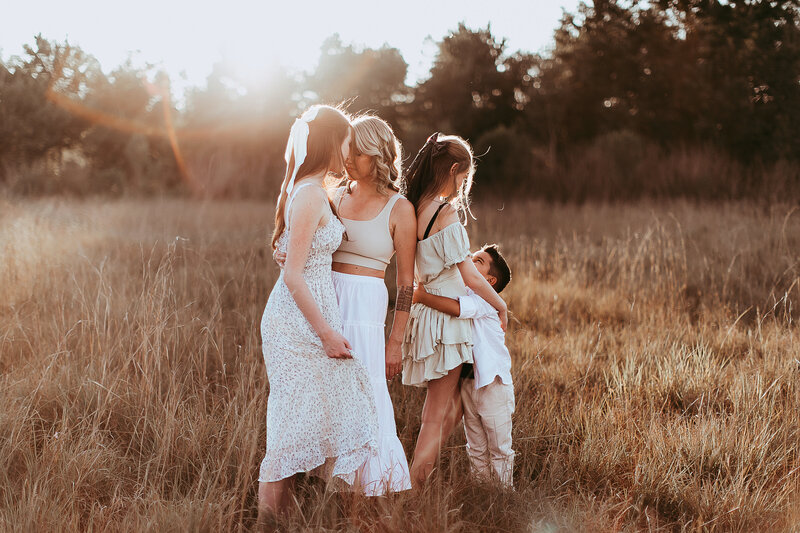 Mom with children in wheat field for a family sessions in Tampa Florida.