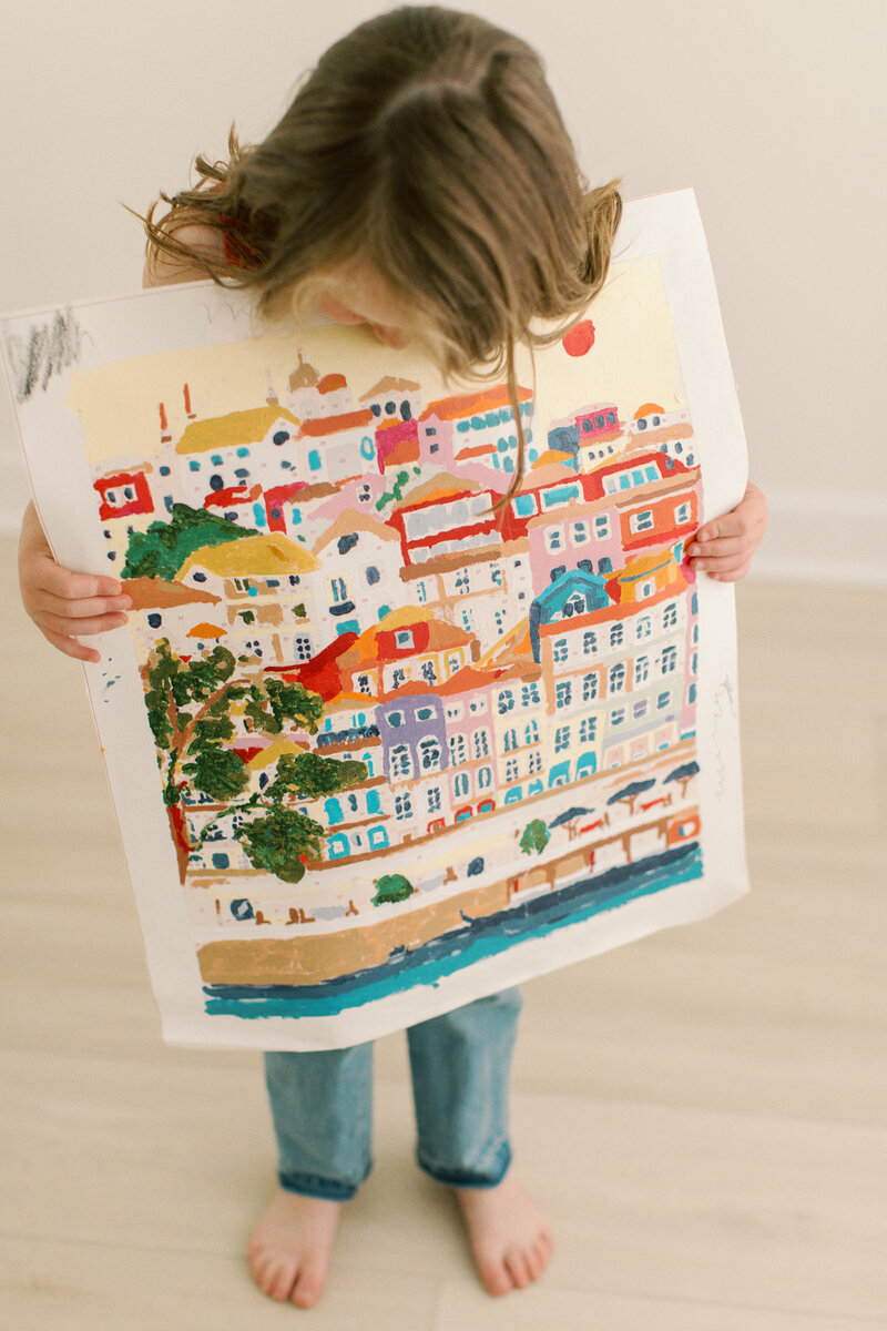 child holding a painting