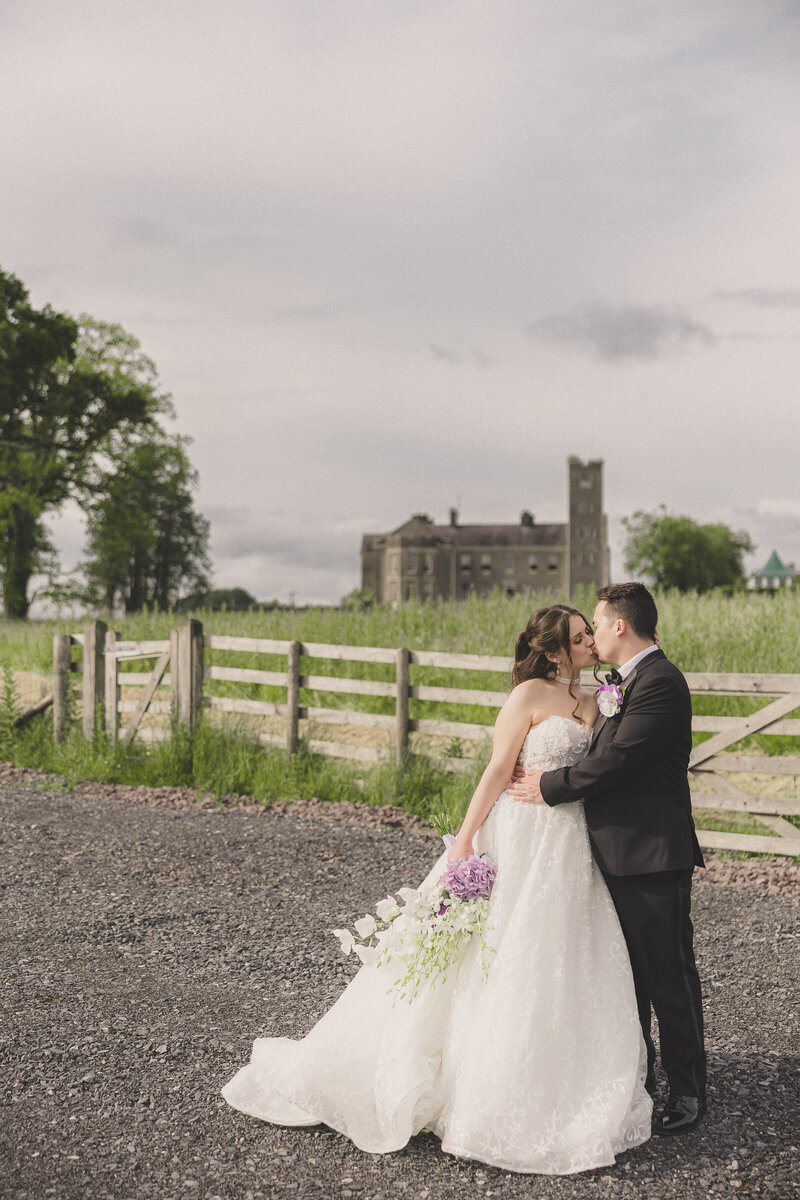 bride and groom share a kiss during bridal portraits for their destination wedding at bell isle estate castle and cottages in northern ireland