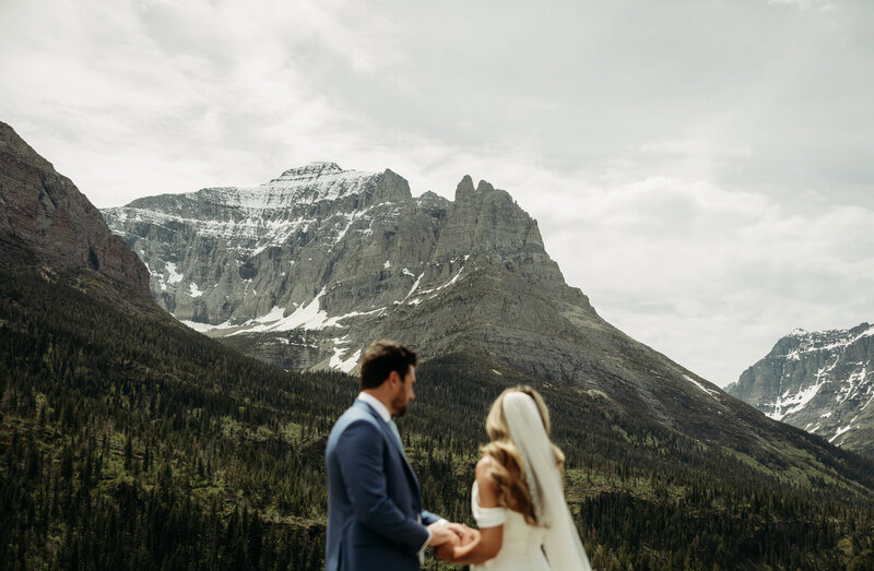 couple looking at mountain scapes surrounded by snow and gorgeous water