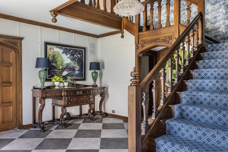 entryway with checkered flooring and wood accents