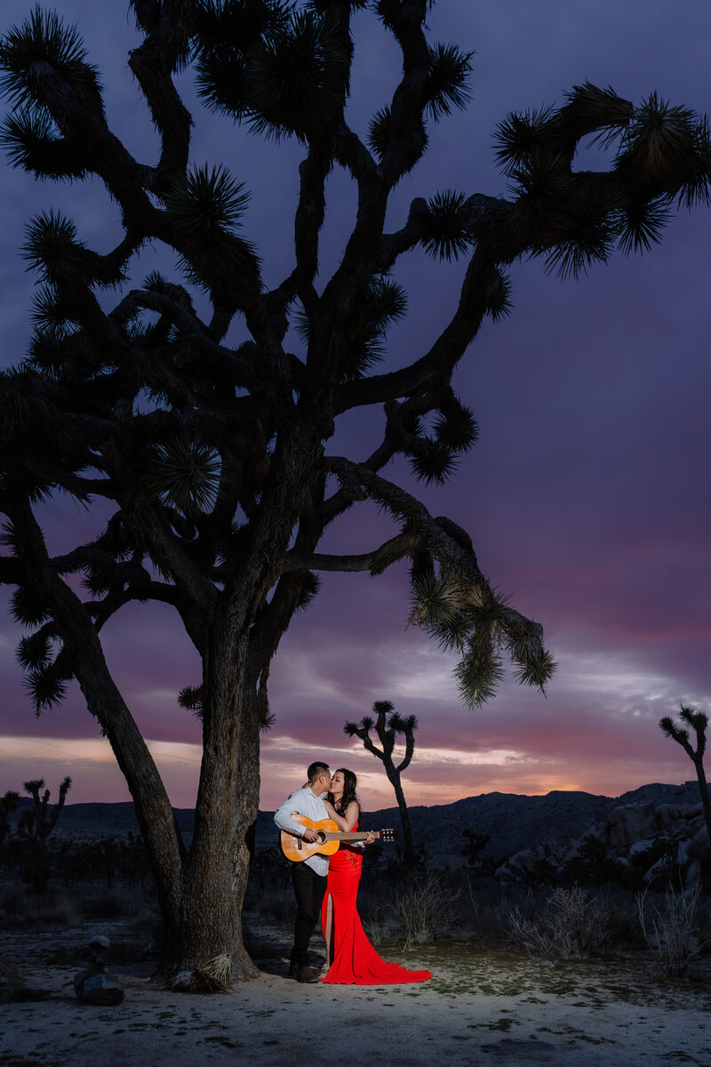 Joshua Tree engagement photos with Asian couple wearing Vietnamese Ao Dai in Hidden Valley during night.