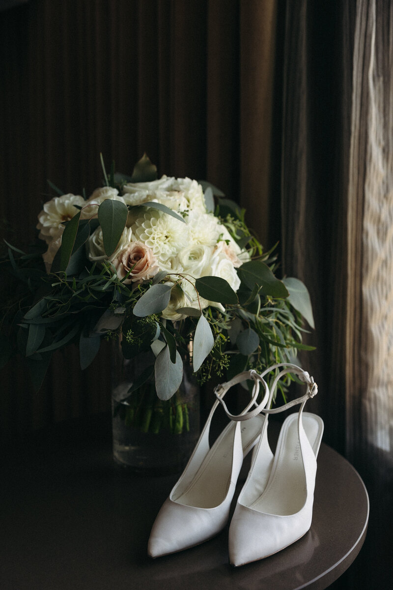 Close-up of a bridal bouquet and wedding shoes, showcasing elegant details for the big day in Columbus, Ohio.