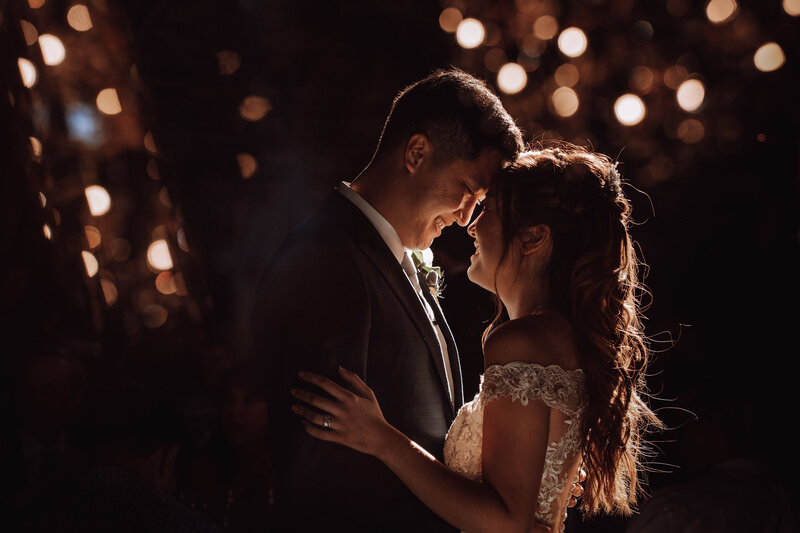 A couple dances in dreamy lighting.