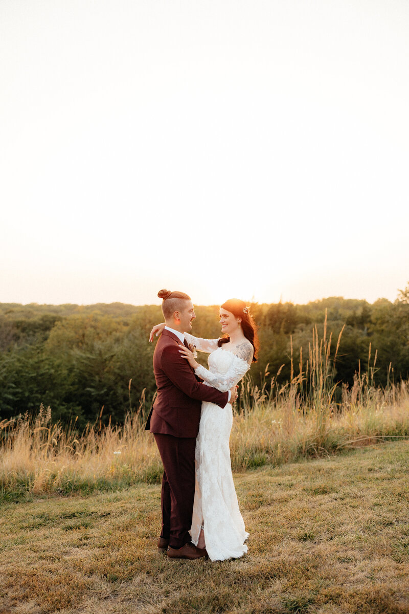 A couple standing in front of a beautiful landscape.