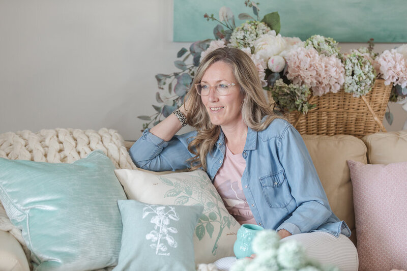 Kimberly Campbell sitting in farmhouse chic living room