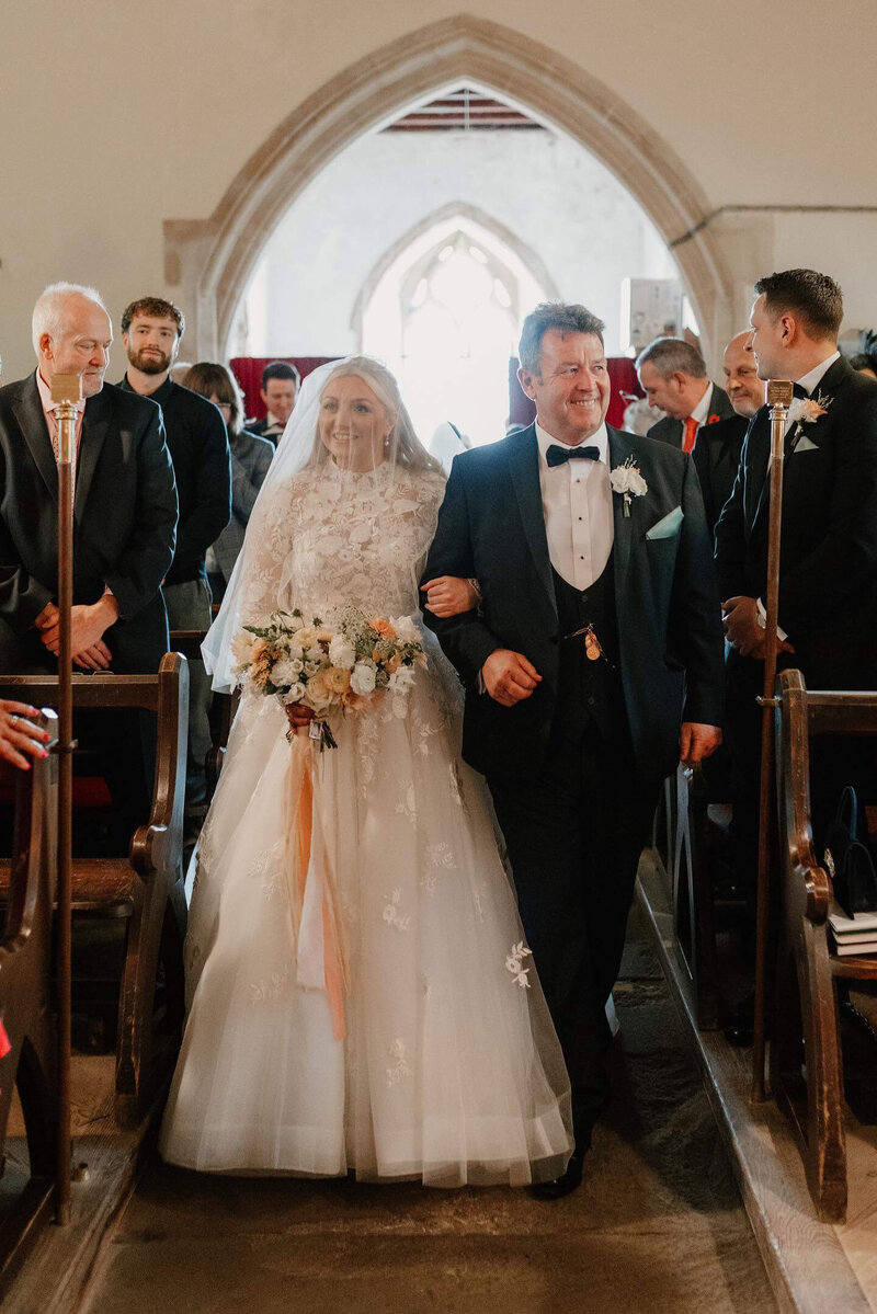 bride and dad walking down the aisle of the church at Sant frraed House
