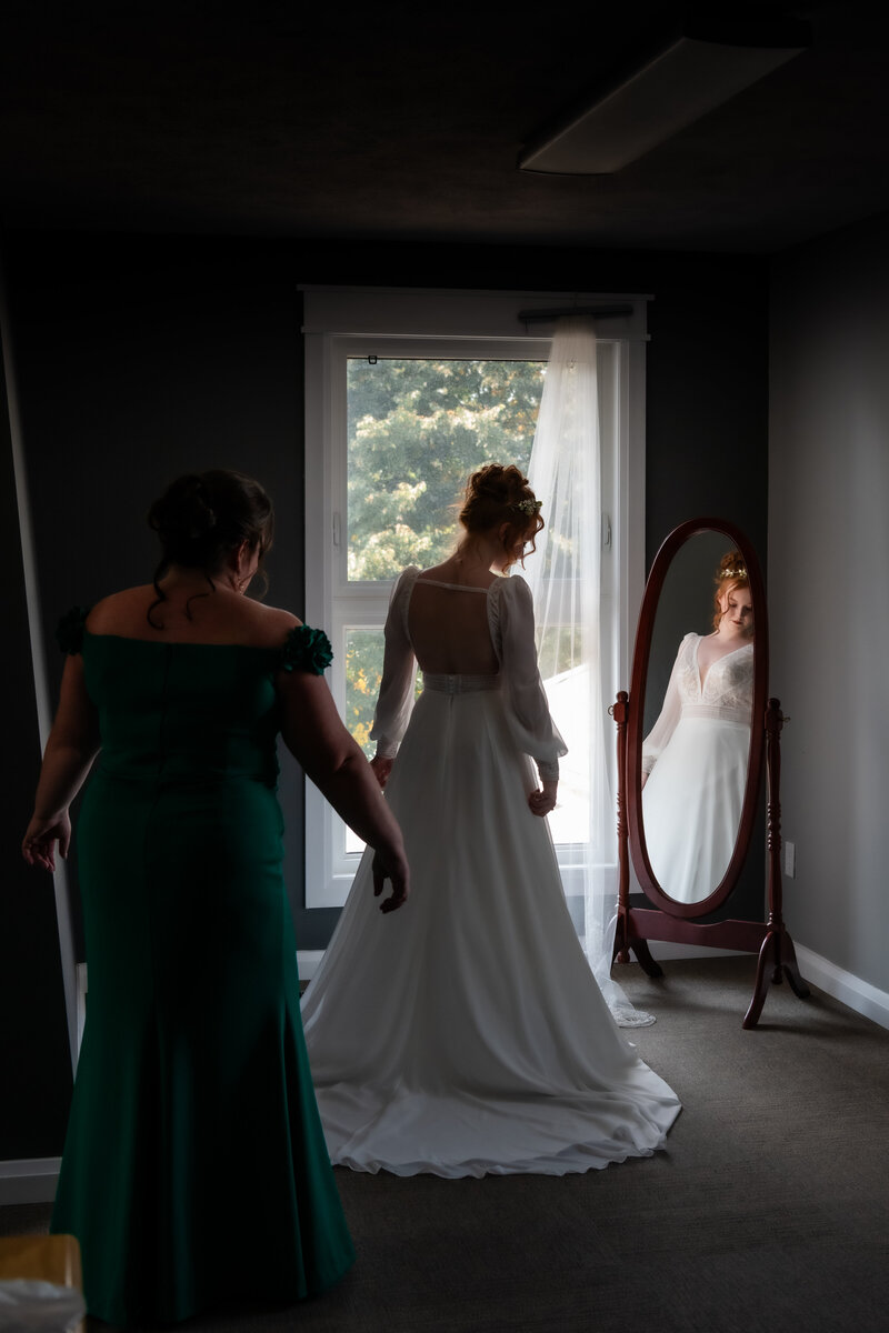 groom in white tuxedo kisses brides shoulder during speeches at Toronto bar wedding