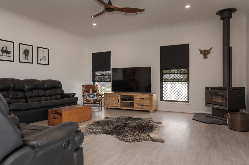 Comfortable living area with Roman blinds, combining timeless style with light-filtering functionality.