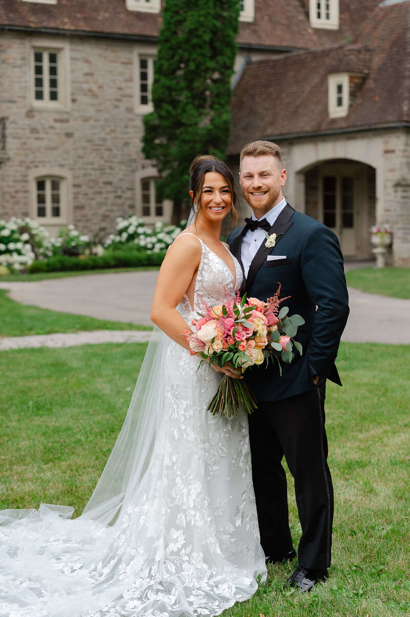 Ottawa wedding photo of a full length portrait of a bride and groom outside of Eaton Hall in Toronto.