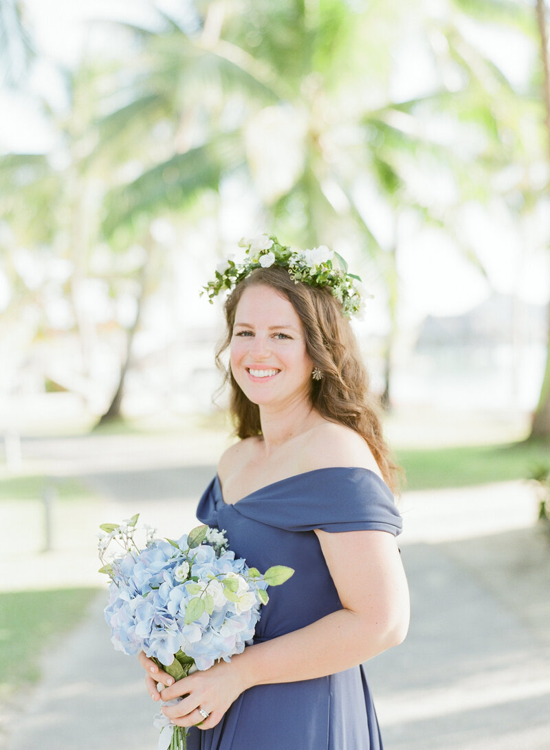 Close portrait Nina elegant woman in Bora Bora nice flowers crown and bouquet