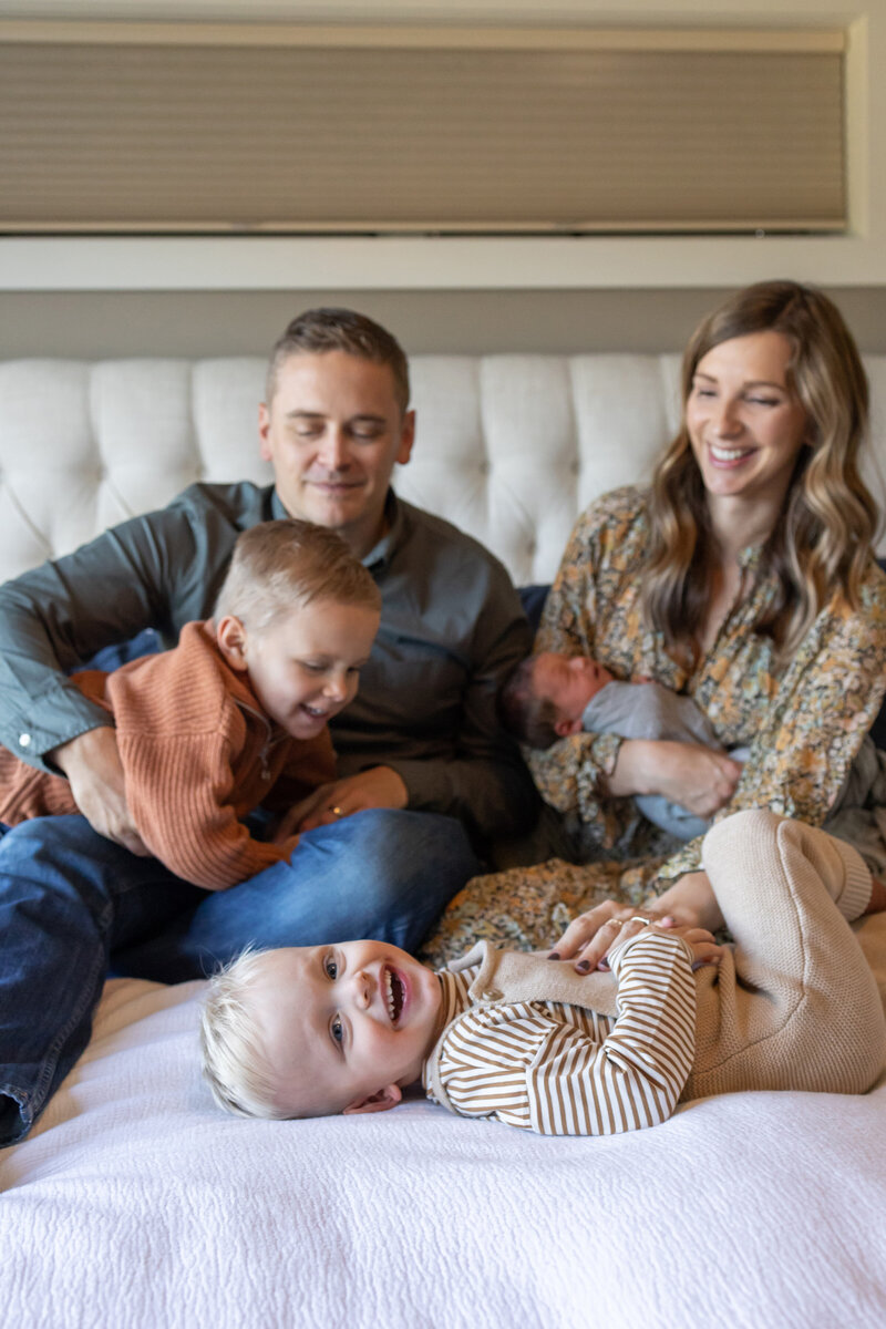 Family on bed with newborn - Jen Madigan - Naperville IL Lifestyle Newborn Photography