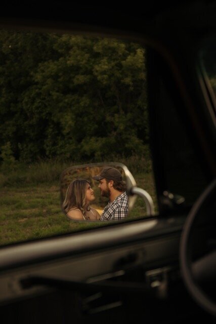 Romantic sunset embrace in a windswept field, photographed with a storytelling 