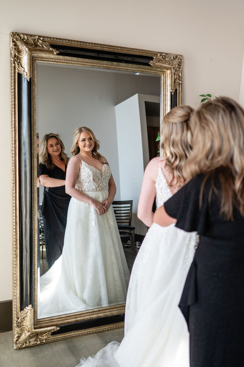 Bride getting ready in front of mirror