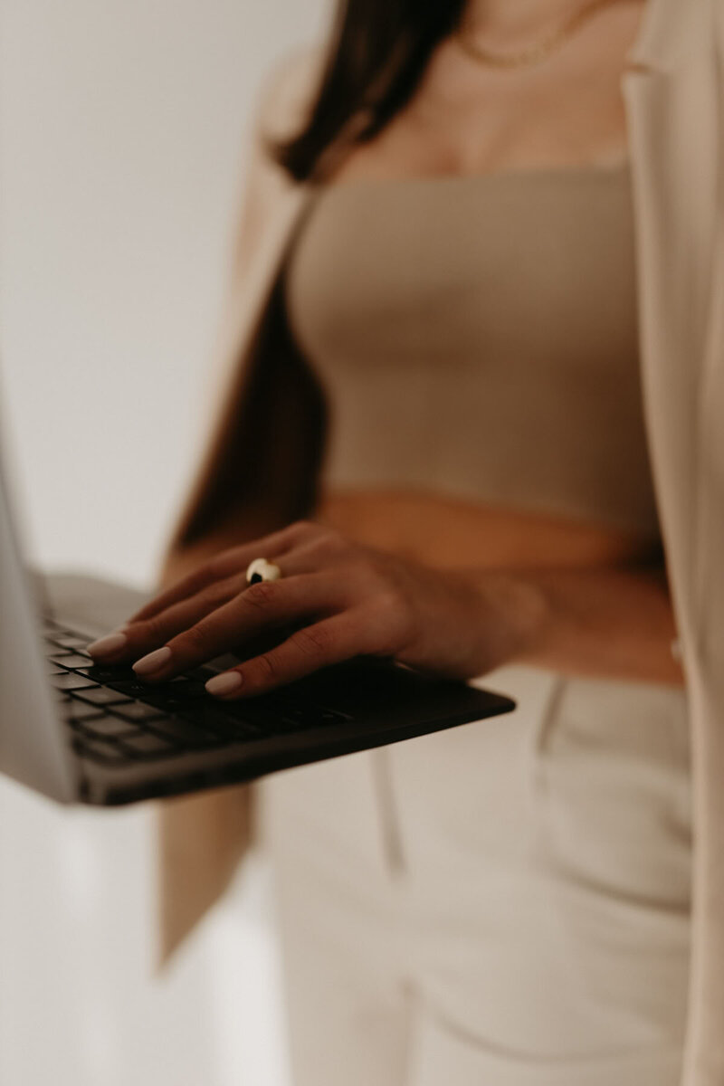 Woman working on a laptop – representing custom web design services by Karla Jane Web Design.