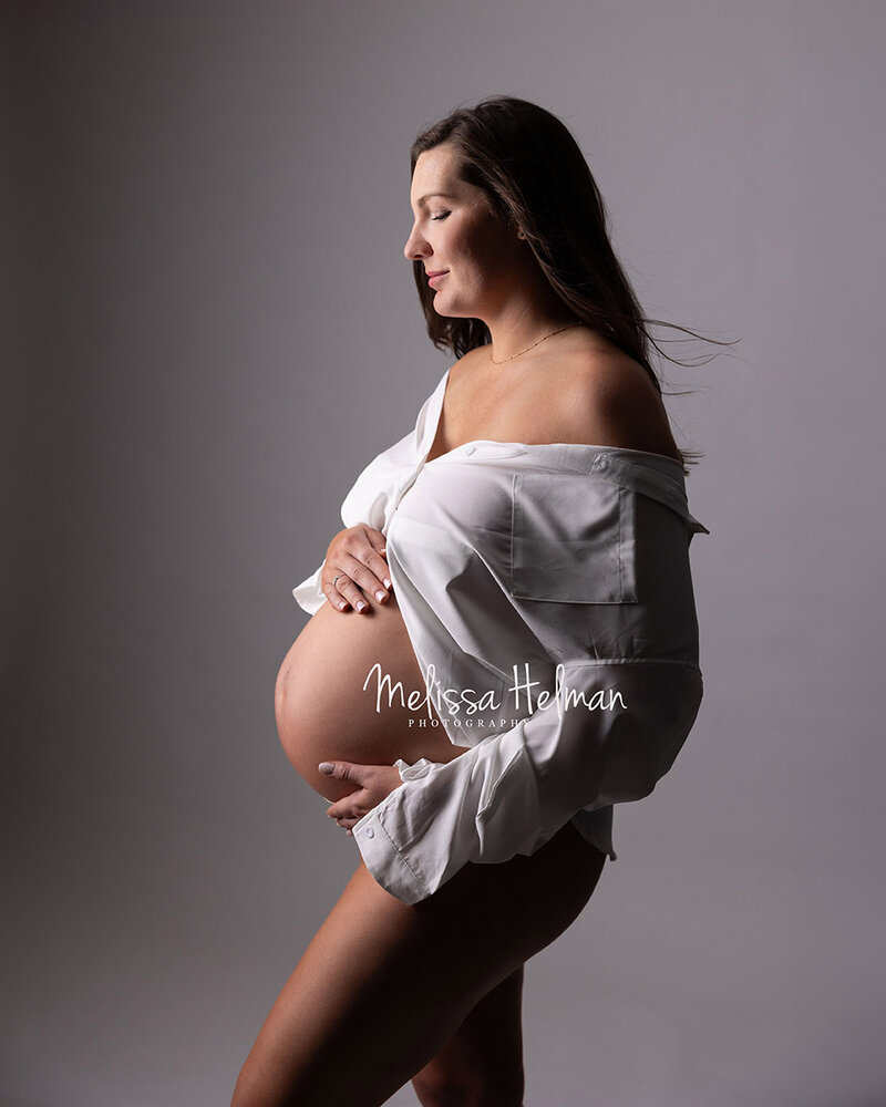 Mom to be stands and poses  for her editorial style maternity session in Cranberry.