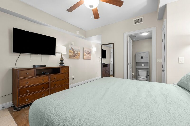 king bed with teal coverlet