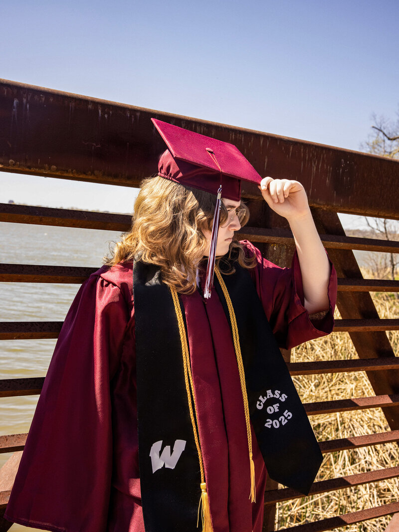 a high school senior posing in her cap and gown