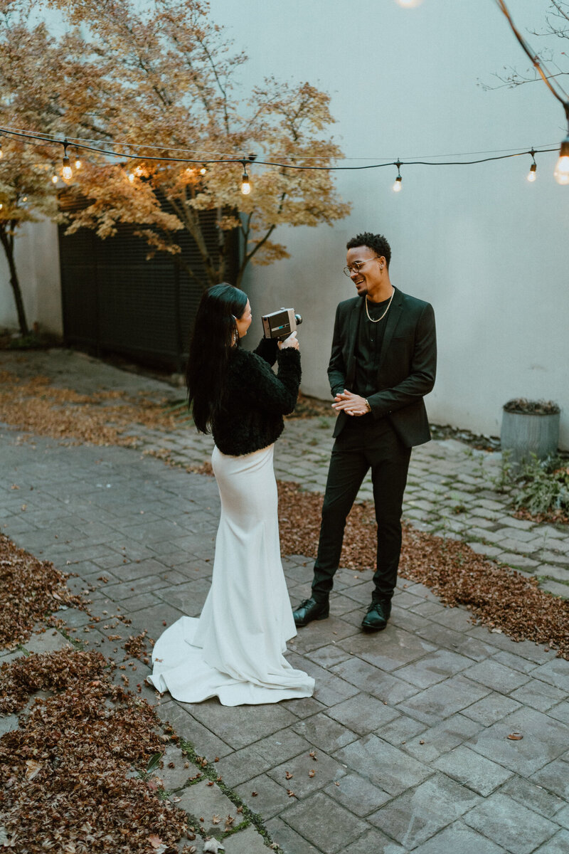 bride and groom laughing in alley at dusk