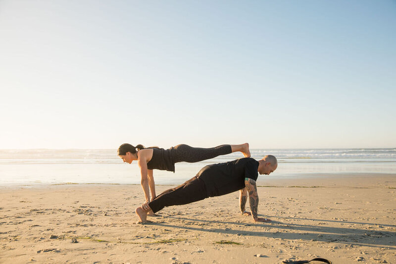 Jackie and Scott of Iron and Salt Fitness doing a double plank workout on a Marin County beach.