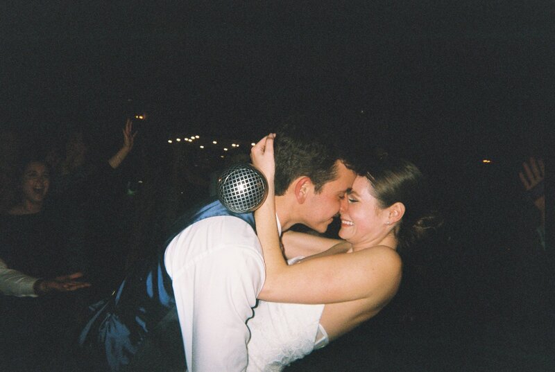 Flash film photo of a bride with drinks in both hands
