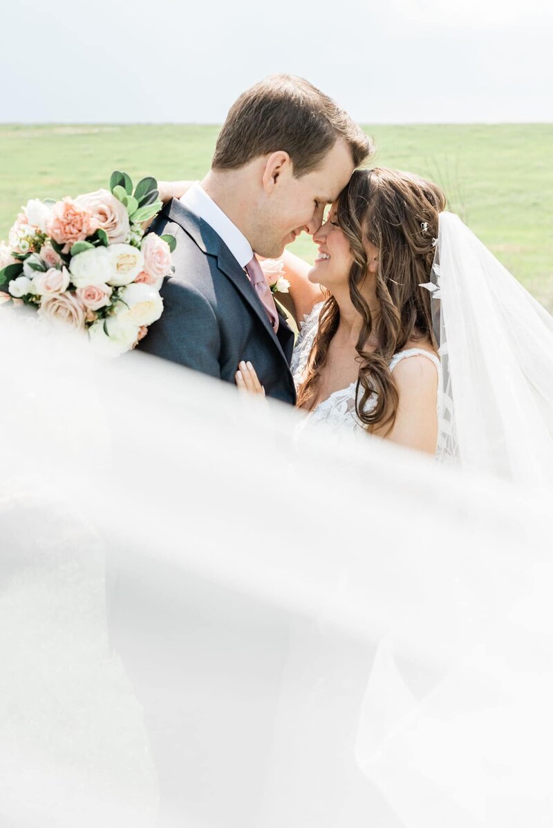 A romantic photograph of the wedding couple at the August House Venue, a charming location in Dickinson, ND.