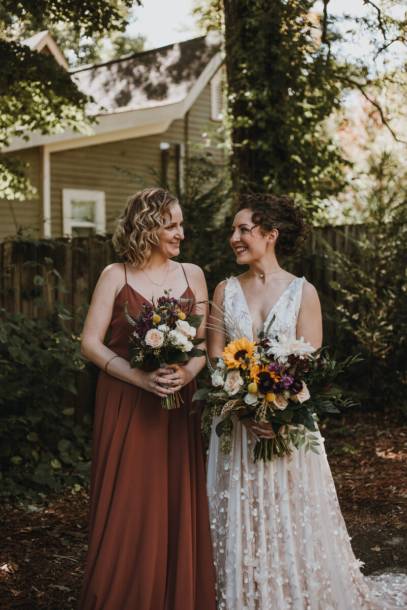 bride smiling at her sister in a garden