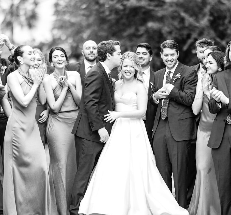 A bride and groom surrounded by their bridal party in Charleston