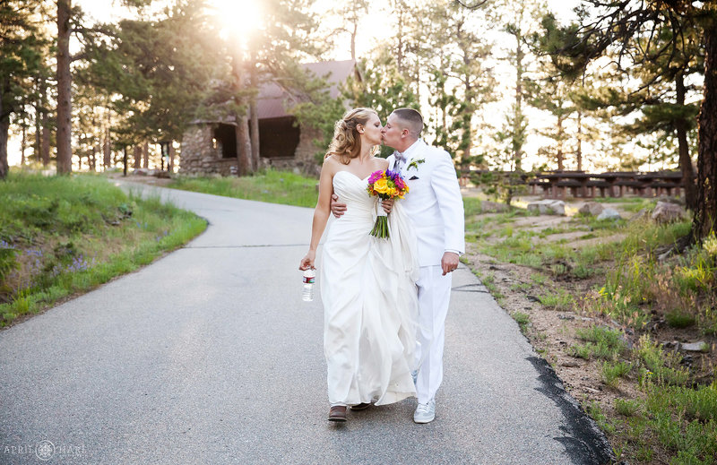 Bride and groom walk from the Stone House to their wedding at Sunrise Amphitheater