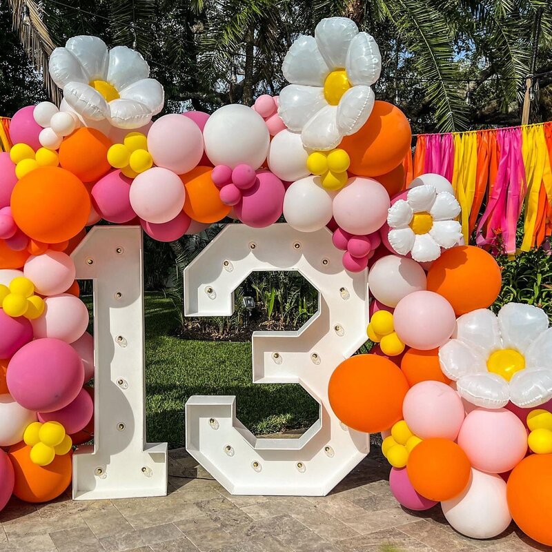 flower power birthday party with big LED  numbers, balloons, and flowers