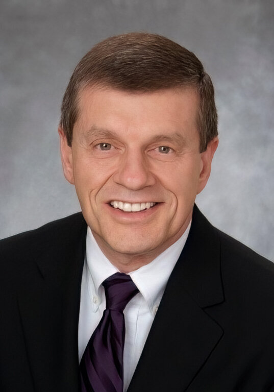 Photographer, Ron Cirullo, smiles for camera in suit